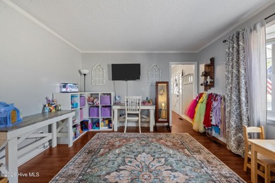 Welcome home! This spacious 4-bedroom 2.5 bathroom beauty is on Jacksonville Country Club in North Carolina - for sale on GolfHomes.com, golf home, golf lot