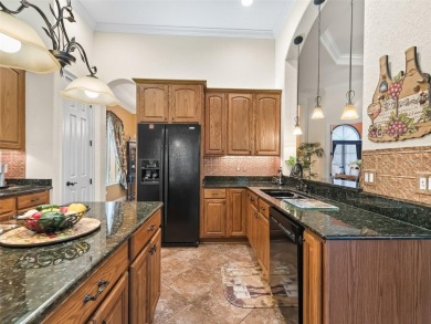IMPROVED PRICE--An iconic palm tree and elegant paver driveway on Harbor Hills Country Club in Florida - for sale on GolfHomes.com, golf home, golf lot