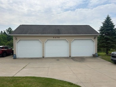 Nestled on two spacious lots totaling 0.79 acres with just one on Sugar Springs Country Club in Michigan - for sale on GolfHomes.com, golf home, golf lot