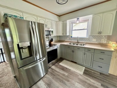 Nestled on two spacious lots totaling 0.79 acres with just one on Sugar Springs Country Club in Michigan - for sale on GolfHomes.com, golf home, golf lot