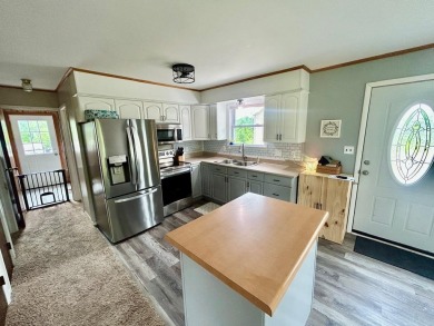 Nestled on two spacious lots totaling 0.79 acres with just one on Sugar Springs Country Club in Michigan - for sale on GolfHomes.com, golf home, golf lot