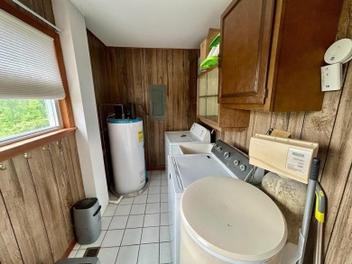 Nestled on two spacious lots totaling 0.79 acres with just one on Sugar Springs Country Club in Michigan - for sale on GolfHomes.com, golf home, golf lot