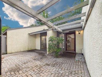 Secluded and beautifully updated, this charming 2-bedroom on Fairway Oaks at Magnolia Golf Course in Florida - for sale on GolfHomes.com, golf home, golf lot