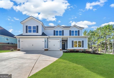 Nestled on the corner lot is an absolute gorgeous new on Canongate At Healy Point Country Club in Georgia - for sale on GolfHomes.com, golf home, golf lot