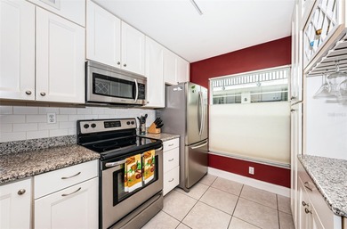 Welcome to this beautifully maintained turnkey 2-bedroom on Isla Del Sol Yacht and Country Club in Florida - for sale on GolfHomes.com, golf home, golf lot