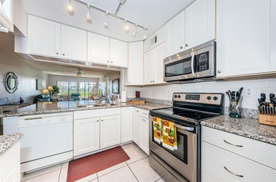 Welcome to this beautifully maintained turnkey 2-bedroom on Isla Del Sol Yacht and Country Club in Florida - for sale on GolfHomes.com, golf home, golf lot