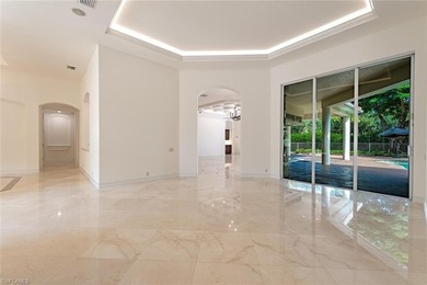 Tucked away on a quiet, tree-lined street in the exclusive on Colliers Reserve Country Club in Florida - for sale on GolfHomes.com, golf home, golf lot