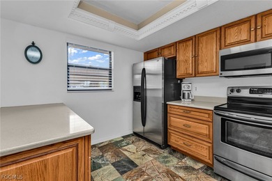 Just steps from your screened lanai to your private dock and on Saint Andrews South Golf Club in Florida - for sale on GolfHomes.com, golf home, golf lot