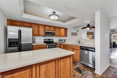 Just steps from your screened lanai to your private dock and on Saint Andrews South Golf Club in Florida - for sale on GolfHomes.com, golf home, golf lot