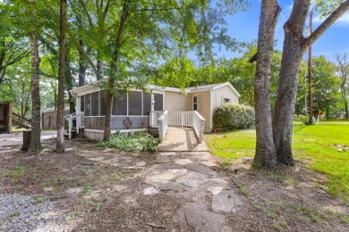 Discover this charming 2-bedroom, 2-bath retreat nestled under a on Links At Lands End in Texas - for sale on GolfHomes.com, golf home, golf lot