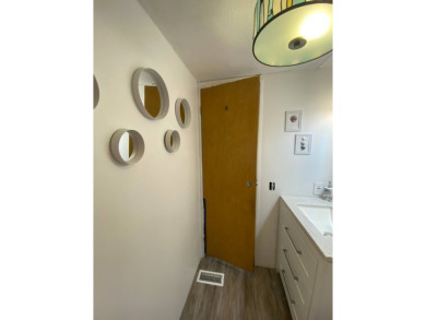 This 2/1.5 manufactured home is priced to sell. It is nestled up on Lake Henry Golf Club in Florida - for sale on GolfHomes.com, golf home, golf lot