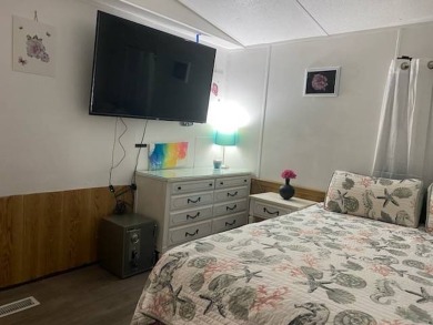 This 2/1.5 manufactured home is priced to sell. It is nestled up on Lake Henry Golf Club in Florida - for sale on GolfHomes.com, golf home, golf lot