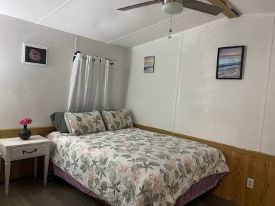 This 2/1.5 manufactured home is priced to sell. It is nestled up on Lake Henry Golf Club in Florida - for sale on GolfHomes.com, golf home, golf lot