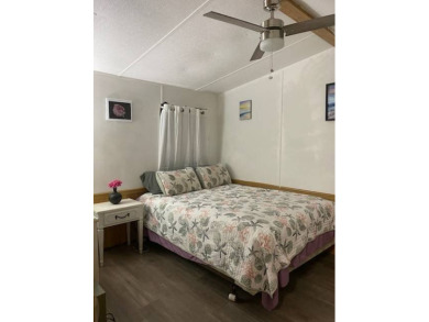 This 2/1.5 manufactured home is priced to sell. It is nestled up on Lake Henry Golf Club in Florida - for sale on GolfHomes.com, golf home, golf lot