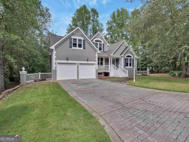 Step into a golfer's dream, tucked away in the renowned Reynolds on Great Waters Course At Reynolds Plantation in Georgia - for sale on GolfHomes.com, golf home, golf lot