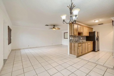 Discover this charming 2-bedroom, 2-bathroom villa in the on Cypress Lakes Golf Course - West Palm Beach in Florida - for sale on GolfHomes.com, golf home, golf lot