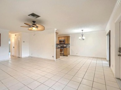 Discover this charming 2-bedroom, 2-bathroom villa in the on Cypress Lakes Golf Course - West Palm Beach in Florida - for sale on GolfHomes.com, golf home, golf lot