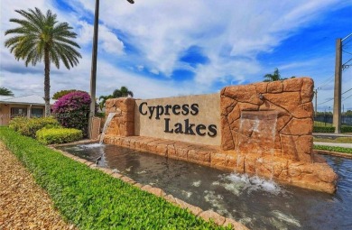 Discover this charming 2-bedroom, 2-bathroom villa in the on Cypress Lakes Golf Course - West Palm Beach in Florida - for sale on GolfHomes.com, golf home, golf lot