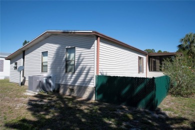 This home sits on a corner lot near our 18-hole golf course. It on Barefoot Bay Golf Course in Florida - for sale on GolfHomes.com, golf home, golf lot