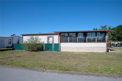 This home sits on a corner lot near our 18-hole golf course. It on Barefoot Bay Golf Course in Florida - for sale on GolfHomes.com, golf home, golf lot