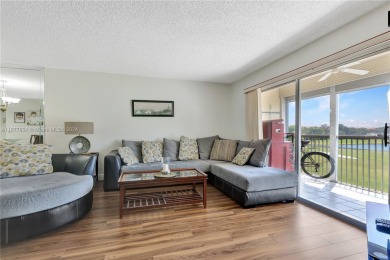 Enjoy beautiful golf course views from the large screened porch on Flamingo Lakes Country Club in Florida - for sale on GolfHomes.com, golf home, golf lot