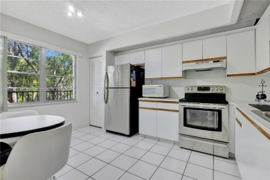 Enjoy beautiful golf course views from the large screened porch on Flamingo Lakes Country Club in Florida - for sale on GolfHomes.com, golf home, golf lot