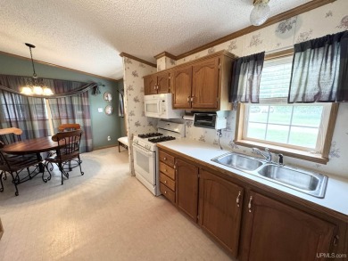 Welcome to this well-maintained 3-bedroom, 2-bath manufactured on Crystal View Municipal Golf Course in Michigan - for sale on GolfHomes.com, golf home, golf lot