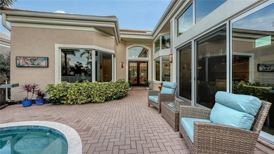 Situated within the gated Queens Harbour enclave of Bay Isles on Longboat Key Golf Club Resort in Florida - for sale on GolfHomes.com, golf home, golf lot