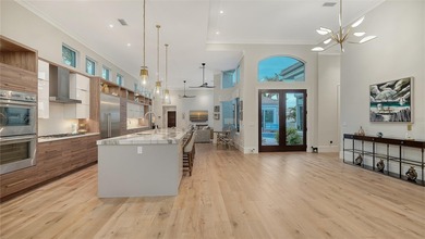 Situated within the gated Queens Harbour enclave of Bay Isles on Longboat Key Golf Club Resort in Florida - for sale on GolfHomes.com, golf home, golf lot