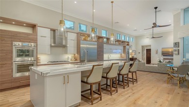 Situated within the gated Queens Harbour enclave of Bay Isles on Longboat Key Golf Club Resort in Florida - for sale on GolfHomes.com, golf home, golf lot