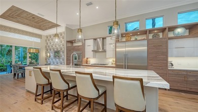 Situated within the gated Queens Harbour enclave of Bay Isles on Longboat Key Golf Club Resort in Florida - for sale on GolfHomes.com, golf home, golf lot