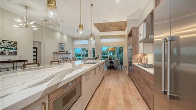 Situated within the gated Queens Harbour enclave of Bay Isles on Longboat Key Golf Club Resort in Florida - for sale on GolfHomes.com, golf home, golf lot