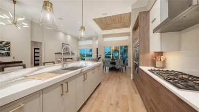 Situated within the gated Queens Harbour enclave of Bay Isles on Longboat Key Golf Club Resort in Florida - for sale on GolfHomes.com, golf home, golf lot