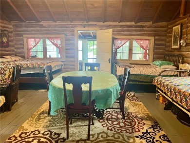Step back in time with this charming, 100+ year-old seasonal log on Minnesota National Golf Course in Minnesota - for sale on GolfHomes.com, golf home, golf lot