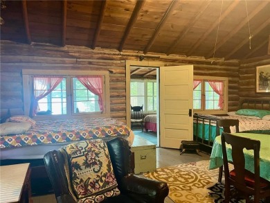 Step back in time with this charming, 100+ year-old seasonal log on Minnesota National Golf Course in Minnesota - for sale on GolfHomes.com, golf home, golf lot