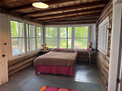 Step back in time with this charming, 100+ year-old seasonal log on Minnesota National Golf Course in Minnesota - for sale on GolfHomes.com, golf home, golf lot
