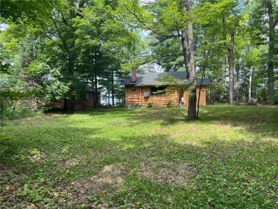 Step back in time with this charming, 100+ year-old seasonal log on Minnesota National Golf Course in Minnesota - for sale on GolfHomes.com, golf home, golf lot