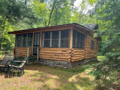 Step back in time with this charming, 100+ year-old seasonal log on Minnesota National Golf Course in Minnesota - for sale on GolfHomes.com, golf home, golf lot