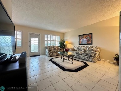 WATER VIEW! Indulge in this luxury 2 bed, 2 bath condo nestled on Hillsboro Pines Golf in Florida - for sale on GolfHomes.com, golf home, golf lot