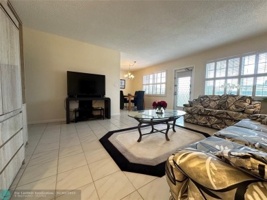 WATER VIEW! Indulge in this luxury 2 bed, 2 bath condo nestled on Hillsboro Pines Golf in Florida - for sale on GolfHomes.com, golf home, golf lot