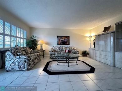 WATER VIEW! Indulge in this luxury 2 bed, 2 bath condo nestled on Hillsboro Pines Golf in Florida - for sale on GolfHomes.com, golf home, golf lot