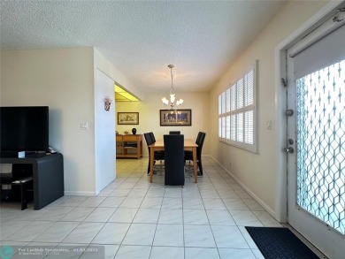 WATER VIEW! Indulge in this luxury 2 bed, 2 bath condo nestled on Hillsboro Pines Golf in Florida - for sale on GolfHomes.com, golf home, golf lot