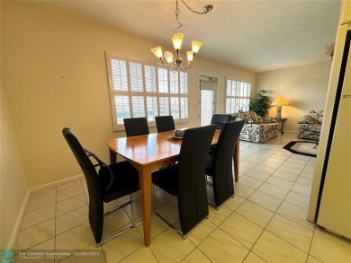 WATER VIEW! Indulge in this luxury 2 bed, 2 bath condo nestled on Hillsboro Pines Golf in Florida - for sale on GolfHomes.com, golf home, golf lot