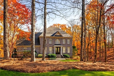 Tucked beneath a canopy of mature hardwoods and overlooking the on Moores Mill Golf Club in Alabama - for sale on GolfHomes.com, golf home, golf lot