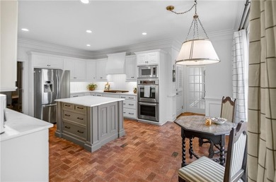 Tucked beneath a canopy of mature hardwoods and overlooking the on Moores Mill Golf Club in Alabama - for sale on GolfHomes.com, golf home, golf lot