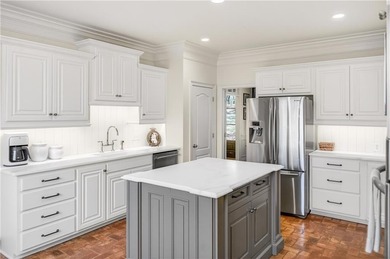 Tucked beneath a canopy of mature hardwoods and overlooking the on Moores Mill Golf Club in Alabama - for sale on GolfHomes.com, golf home, golf lot