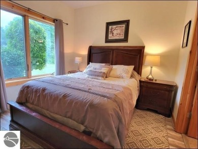 Enjoy resort-style living in this beautifully furnished condo on Schuss Mountain Golf Club in Michigan - for sale on GolfHomes.com, golf home, golf lot