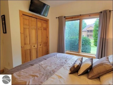 Enjoy resort-style living in this beautifully furnished condo on Schuss Mountain Golf Club in Michigan - for sale on GolfHomes.com, golf home, golf lot