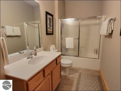 Enjoy resort-style living in this beautifully furnished condo on Schuss Mountain Golf Club in Michigan - for sale on GolfHomes.com, golf home, golf lot