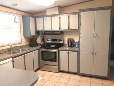 This waterfront 1792 sq ft 3 bedroom manufactured home is in 55+ on Schalamar Creek Golf and Country Club in Florida - for sale on GolfHomes.com, golf home, golf lot